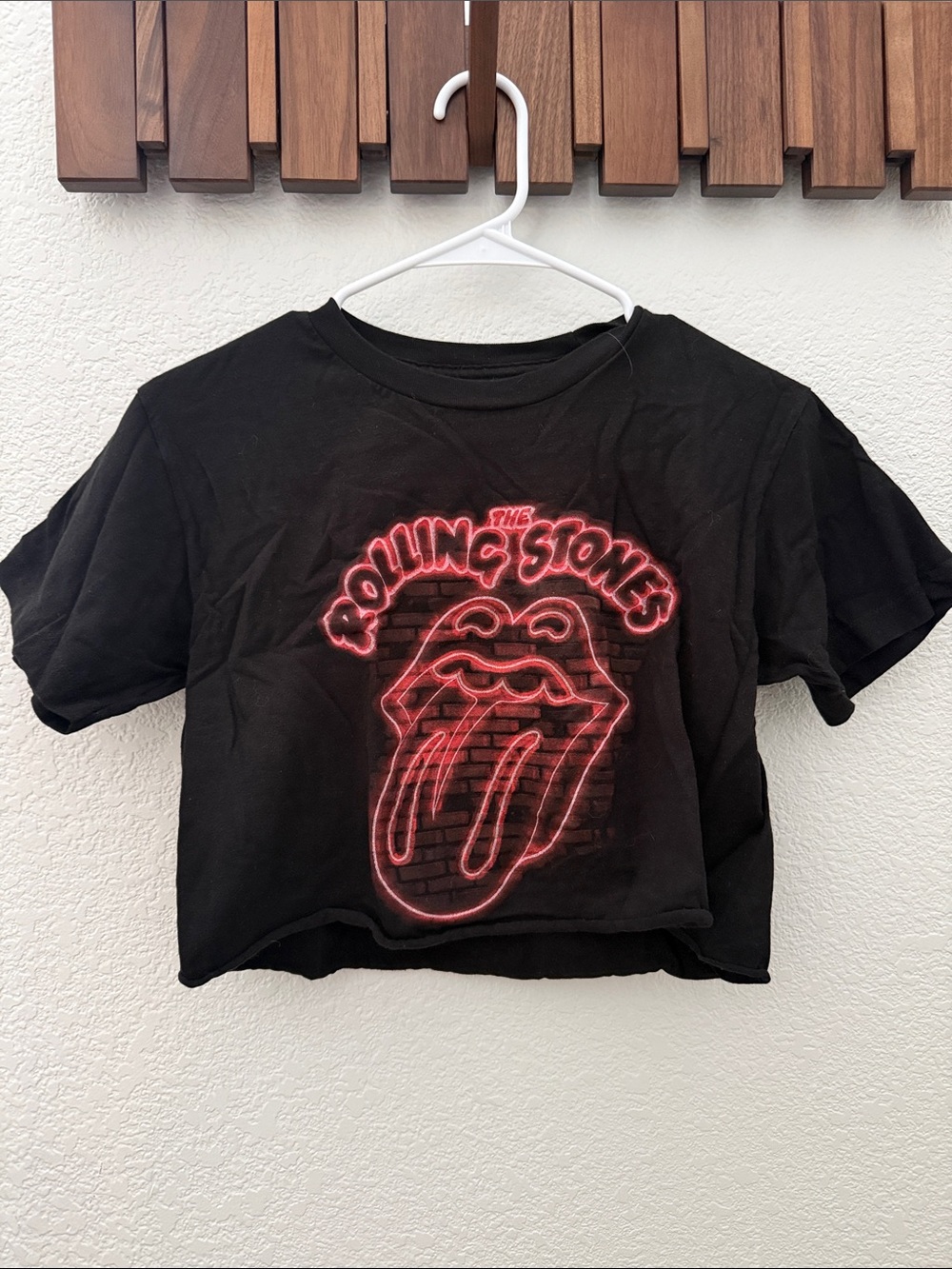 the Rolling Stones Black Crop Tee with Neon Pink Tongue Logo